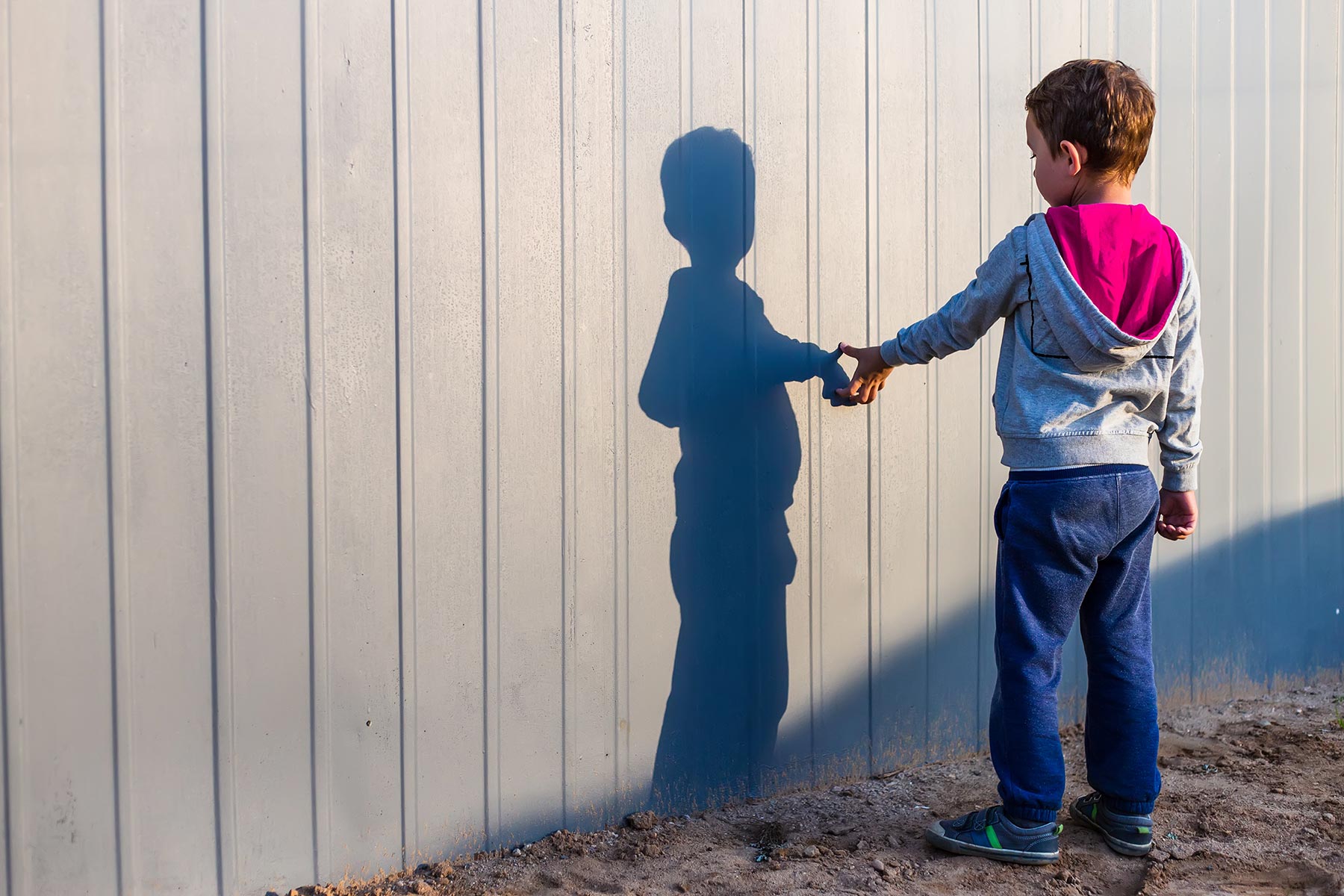 Boy looking at his shadow